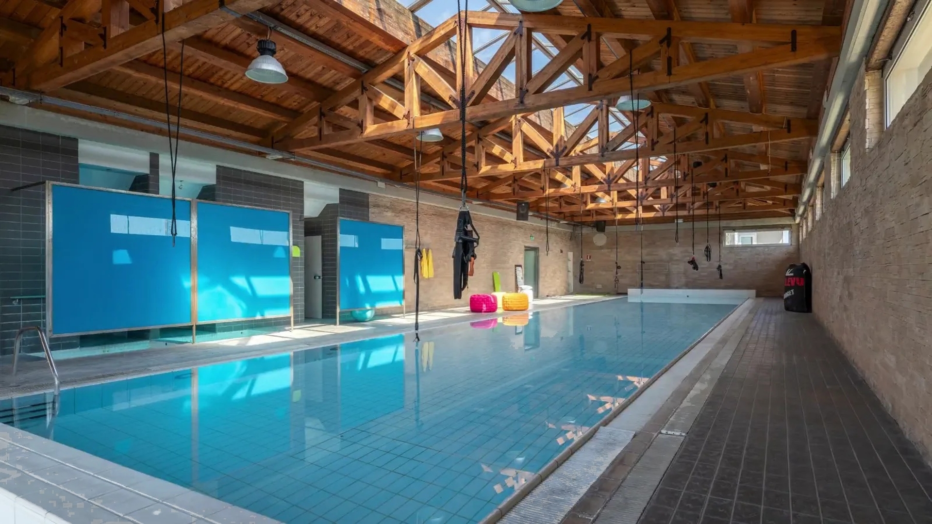 Indoor pool with restored perimeter channel and timber roof